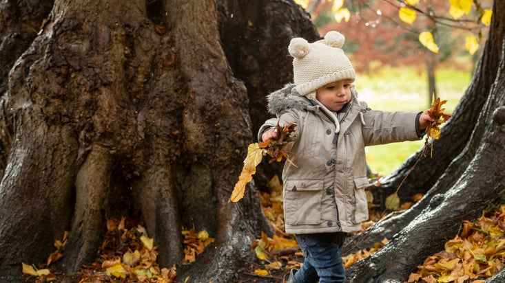 Child in the garden at Kedleston Hall, Derbyshire in autumn